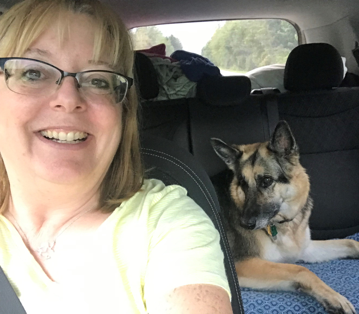 Susan and family dog, Penny, on a road trip.