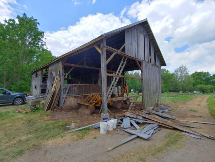Dismantling and reclaiming barn siding during restoration of an Upstate NY family barn.