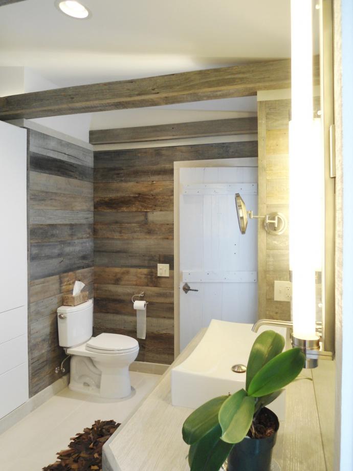 The reclaimed Barn Siding wraps all of the master bath’s walls as well as the box beams at the ceiling. The beams are hollow and incorporate lighting in them to illuminate the ceiling.