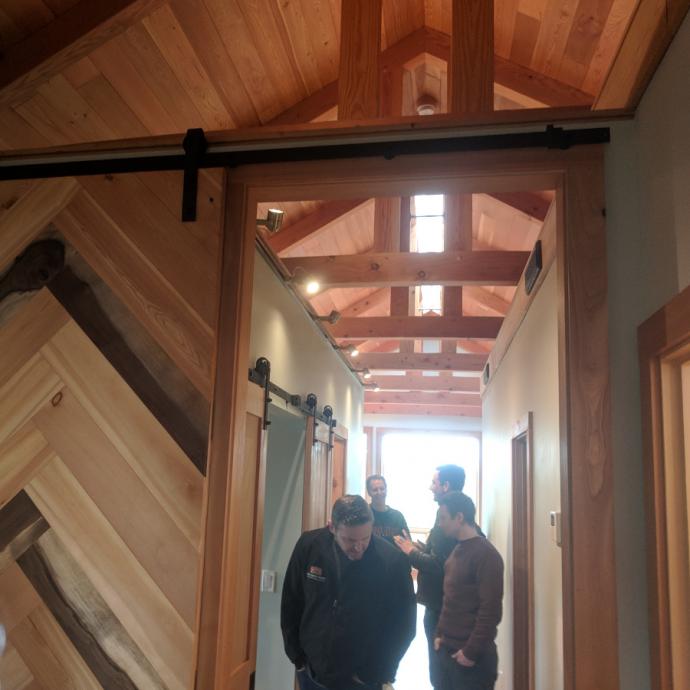 Nothing wasted. Off-cuts of larch and walnut created while crafting pieces for the Jewel were repurposed into a chevron pattern flat track door for the master bedroom.