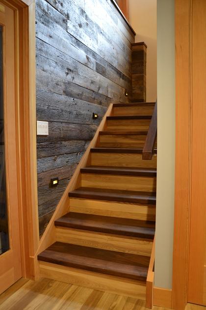 The custom stairs and railing were crafted by NEWwoodworks.