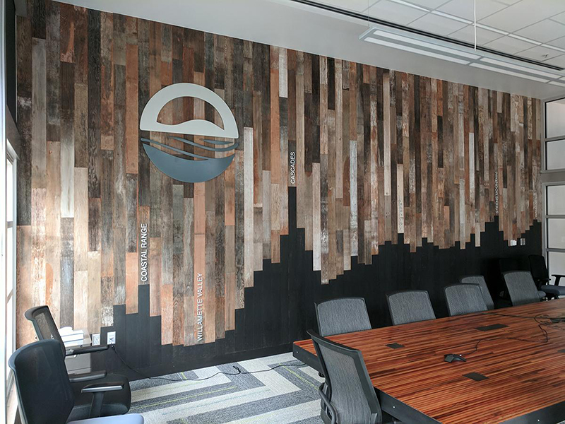 The conference room wall at the Orgeon department of Energy is clad with reclaimed Mixed Softwoods Vat Stock Patina sourced from cherry vats. 