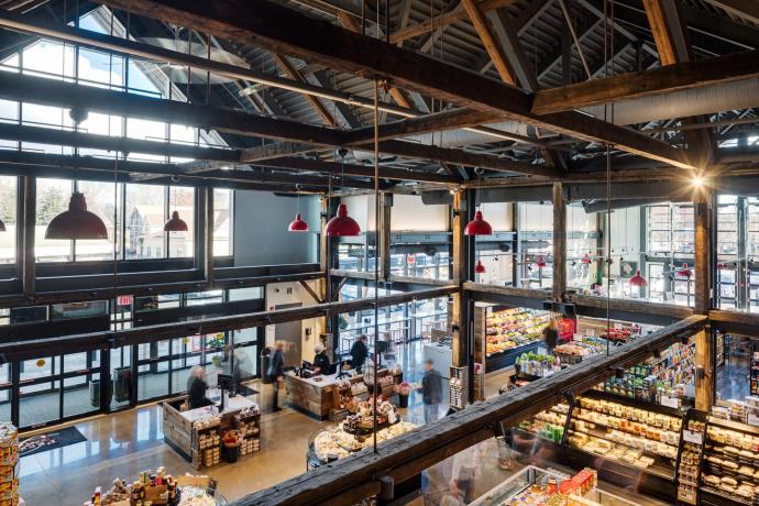 Where the reclaimed timbers meet the modern design elements inside the marketplace. Photography © Greg Premru 2020