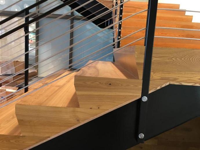A combination of aesthetics and durability have made Ash a premier choice for high traffic areas. Outward-facing, at eye level and above, the stringers as well as treads on these stairs, celebrate the character and tones of AG Reclaimed Ash with a poly finish.