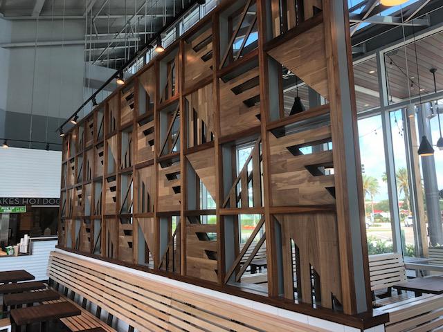 Wood dividing walls are popular for the added dimension, character, and interest they bring to commercial/restaurant spaces. Shown here as Modern Farmhouse Clean Walnut in a Florida location.