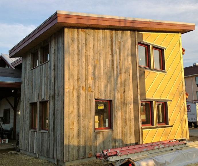 Pioneer Millworks American Prairie Weathered Grey being vertically installed with a vapor barrier (black material) and rain screen (furring strips at a 45 degree angle) over wood fiber insulation.