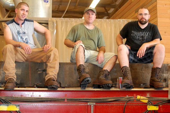TJ, Cal, and Dave modeling the new ‘Rip Saw’ boot from Timberland. Appropriately enough, that timber they’re sitting on is on the deck of our mill’s rip saw.