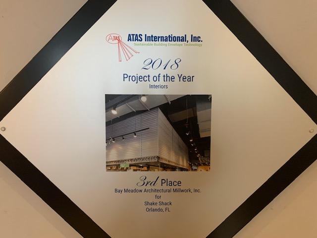 As seen in the Bay Meadow office lobby in Florida; award via a project with our Modern Farmhouse wood paneling.