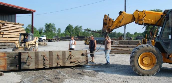 Removing the heavy bolts and bars from the timbers took machine level persuasion.