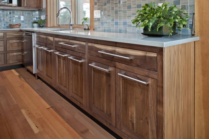 Custom walnut cabinetry was crafted from a site-harvested tree, felled by the homeowner.
