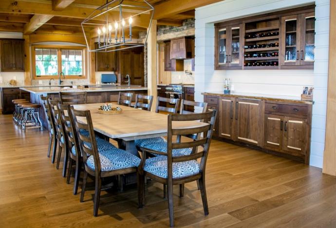 Walnut was the wood of choice for built-ins and custom woodworking pieces, crafted by NEWwoodworks, throughout the main level. Above the clean white oak flooring abuts a custom walnut wine bar in the dining area of the lake home. Photo (C) Scott Hemenway