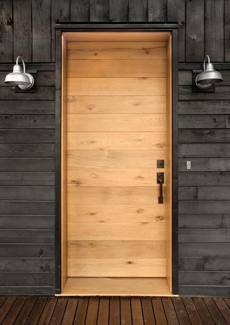 NEWwoodworks crafted the NEW Jewel’s entry door from reclaimed oak. The warm tones welcome visitors and create a visual break from the dark Shou Sugi Ban siding.