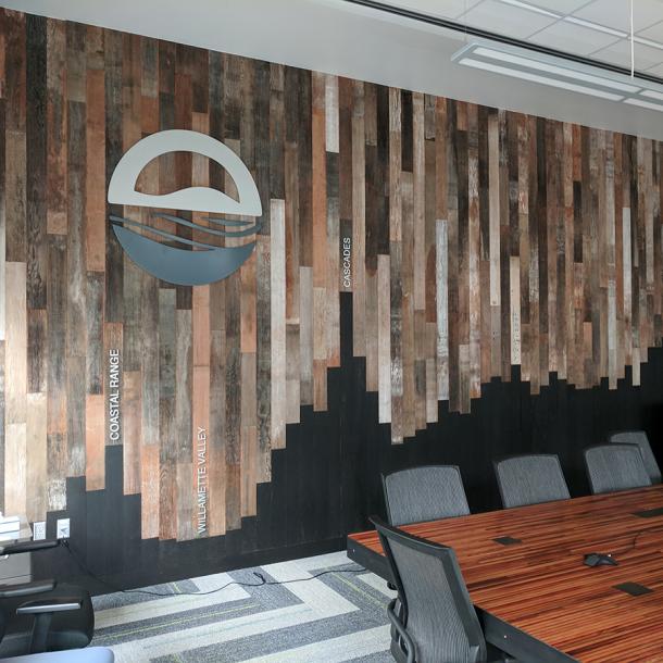 The conference room wall at the Orgeon department of Energy is clad with reclaimed Mixed Softwoods Vat Stock Patina sourced from cherry vats. 