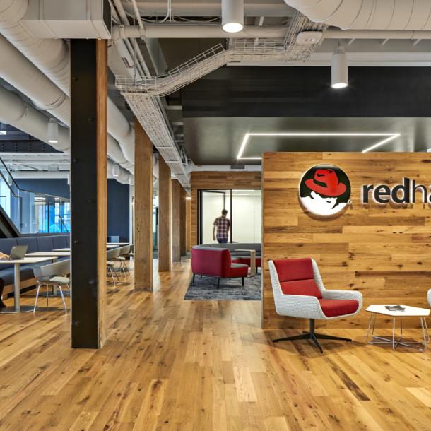 The American Gothic Oak flooring and paneling contrasts well with the branded colors of Red Hat in Boston, MA.