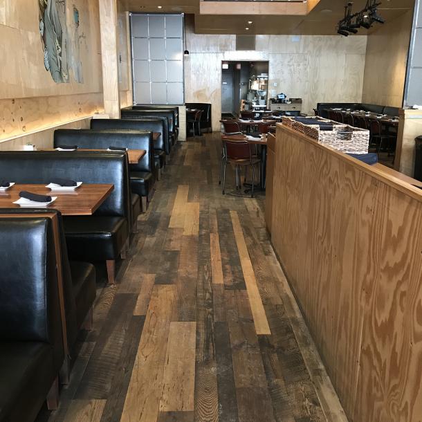 The flooring at Umami Burger in Chicago, IL made up of reclaimed Settlers' Plank Mixed hardwoods.