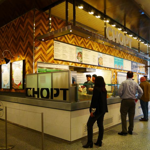 Mixed hardwoods settlers plank reclaimed wall paneling at Chopt in New York City.
