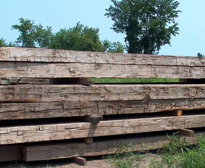 A stack of hand hewn timbers wait in our yard for the next big project.