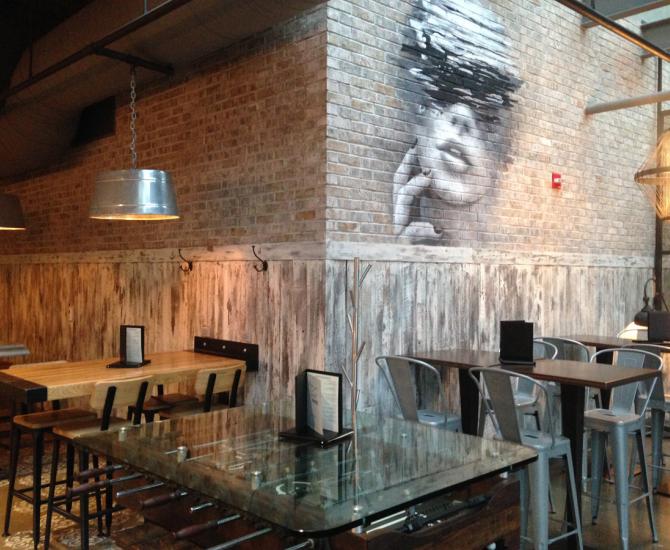 American Prairie Faux Painted paneling wraps around the lower half of this restaurant seating area.