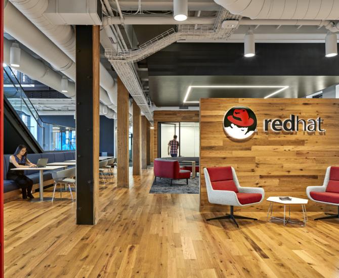 The American Gothic Oak flooring and paneling contrasts well with the branded colors of Red Hat in Boston, MA.