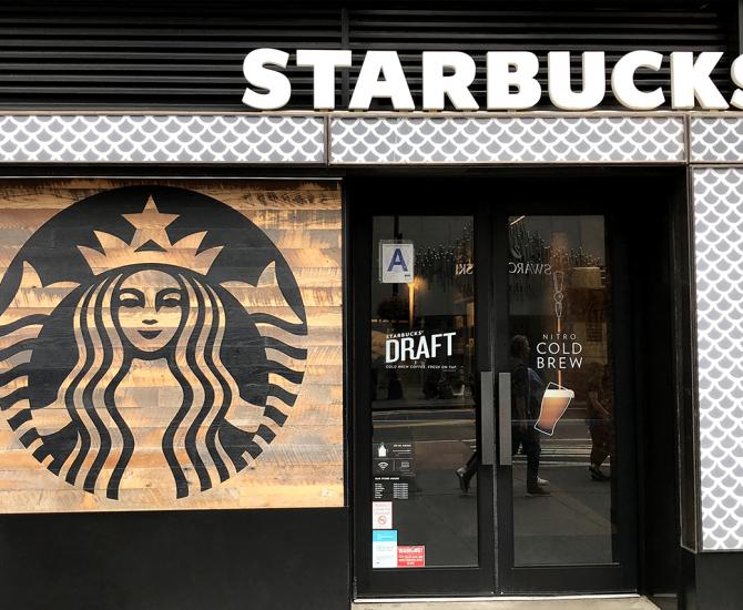 Starbucks logo painted on Settlers' Plank Mixed Oak paneling.