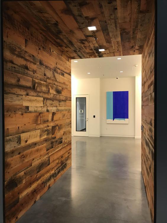 Mixed Softwoods Grandma's Attic reclaimed wood wall paneling  flows through this office hallway