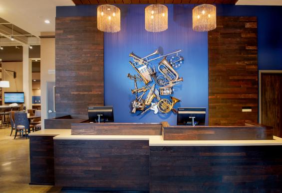 Reclaimed Teak with a custom finish wraps around the hotel lobby front desk area