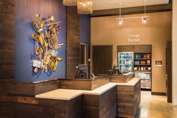 Reclaimed Teak with a custom finish wraps around the hotel lobby front desk area