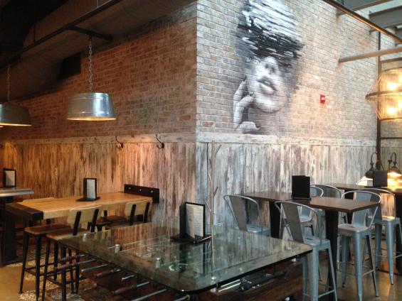 American Prairie Faux Painted paneling wraps around the lower half of this restaurant seating area.