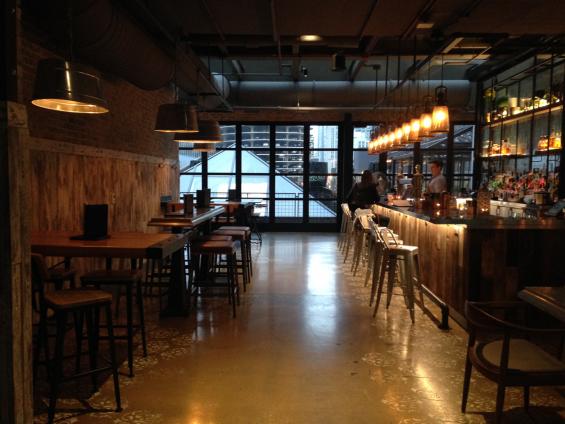 Vat Stock Patina wraps around the bar front, and American Prairie Faux Painted paneling wraps around the lower half of the walls.