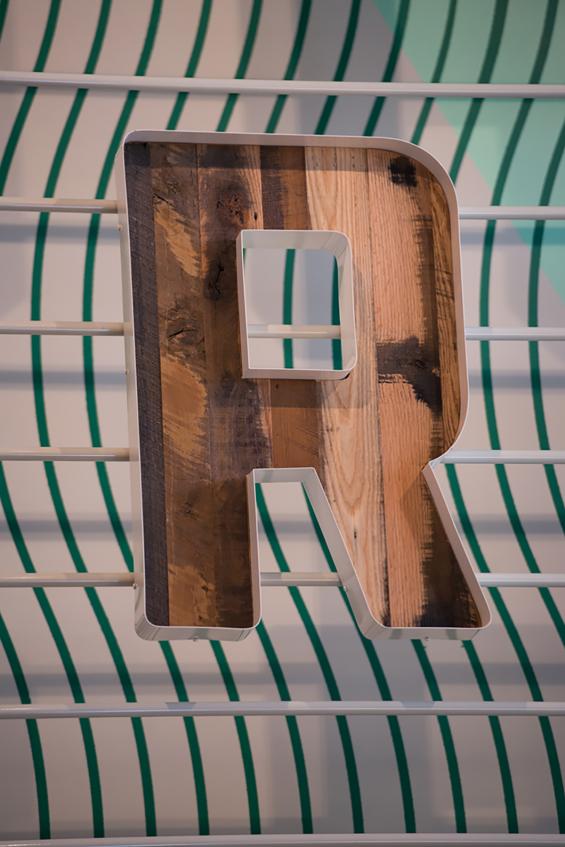 Close up of Settlers' Plank Mixed Hardwoods reclaimed paneling store signage