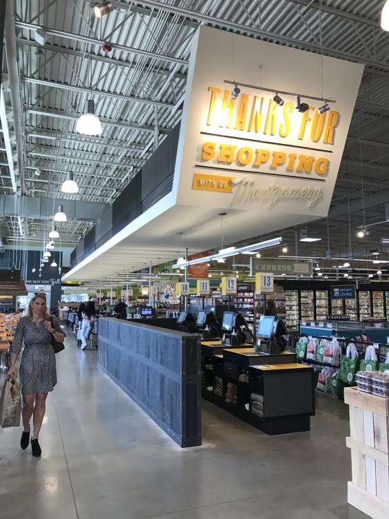 Sanded Railyard Patina Mixed Oak reclaimed wood with a custom black finish is used as wainscoting on cash wraps 