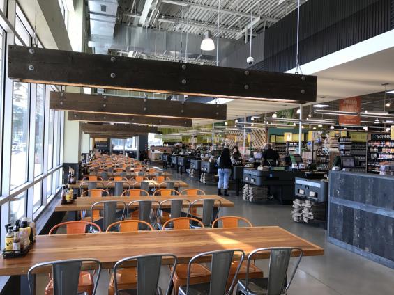 Lighting fixtures were created by banding together 3'x6' beams with metal strapping. Cash wraps are finished with sanded Railyard Patina Mixed Oak wainscoting.