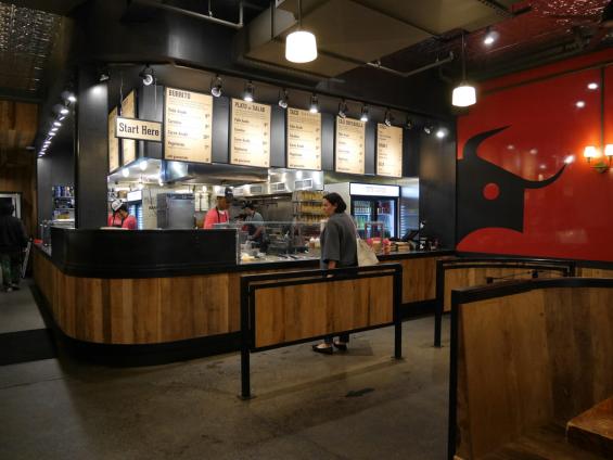Mixed Hardwoods Settlers' Plank wrapped around the ordering counter at Dos Toros Taqueria in New York City