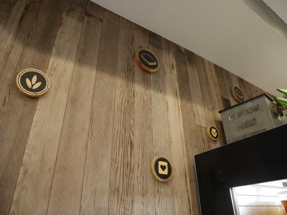 Mixed Softwoods Vat Stock Patina reclaimed from cherry vats is used as paneling throughout the Sandwicherie location near Grand Central. 