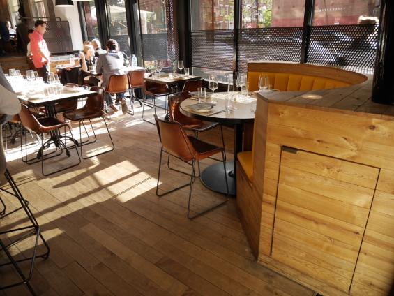 American Gothic Ash reclaimed wood wrapped around this corner booth seating area in Charlie Bird Restaurant