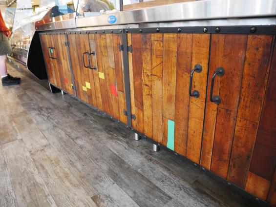 Close up of Foundry Maple reclaimed paneling on the service counter of the Sandwicherie in Union Square
