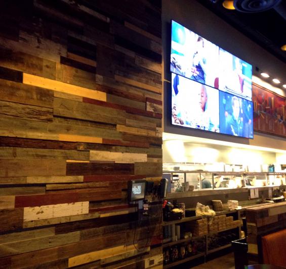A mixture of various grades of reclaimed wood paneling in multiple thicknesses was used to achieve this look at the Brew Brothers restaurant in Columbus, OH