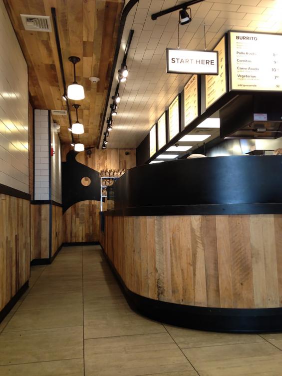 Mixed Hardwoods Settlers' Plank reclaimed wood counter wrap, wall paneling, and ceiling paneling.