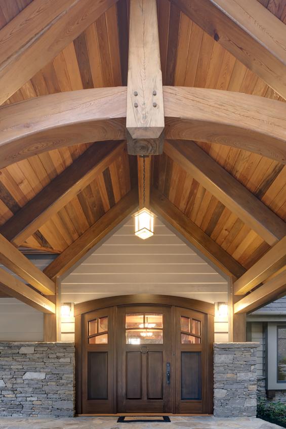 Reclaimed from river bottoms, 'sinker' cypress timbers frame a door of the same wood, but which has a custom stain.