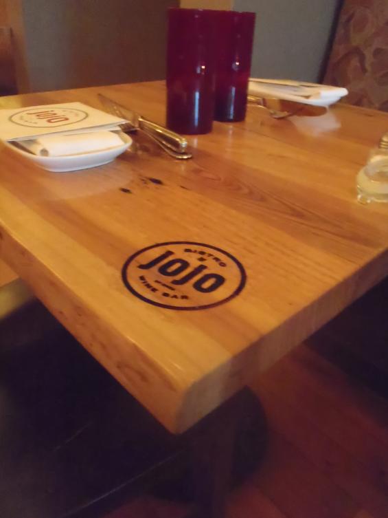 Custom hardwoods tops with branded logo identify this beloved winebar. 