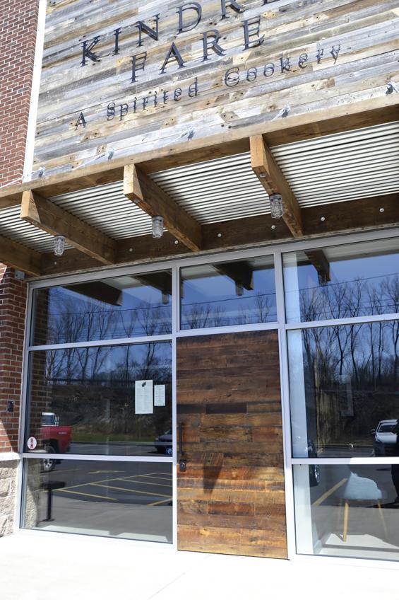 Exterior reclaimed snow fence siding and a custom slab style entry door (made with reclaimed hardwoods) defines the Kindred Fare facia. 