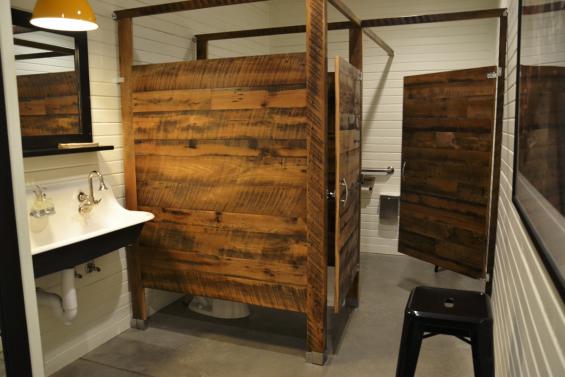 Bathroom stalls and doors also made use of Settlers' Plank Reclaimed Hardwoods.