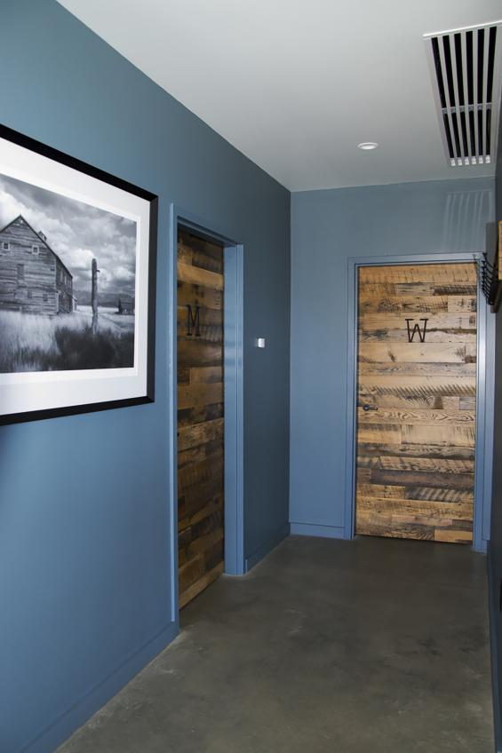 Bathroom entry doors use Settlers' Plank reclaimed hardwoods.