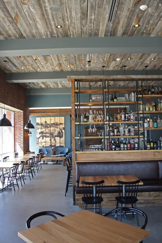 Reclaimed softwoods t&g ceiling joins other reclaimed wood tables, fixtures, cabinetry, doors, and more in Kindred Fare.