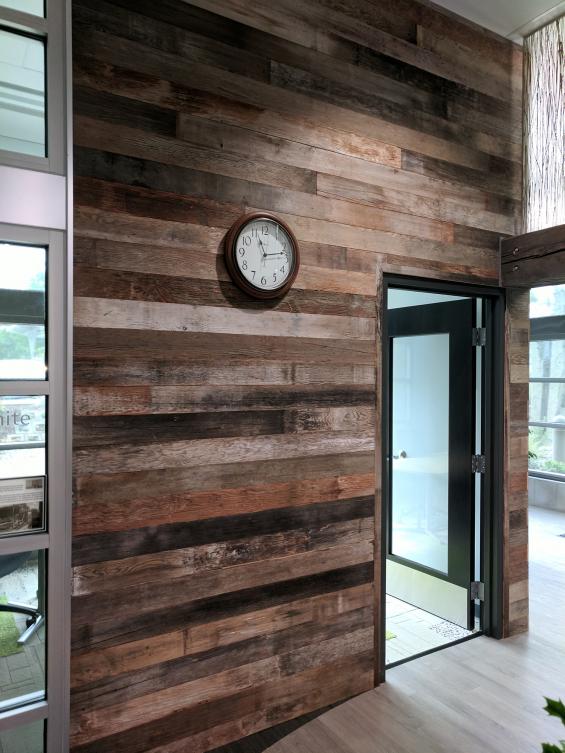 Reclaimed mixed softwoods vat stock patina wall paneling clads the walls of this office in Salem, OR. 
