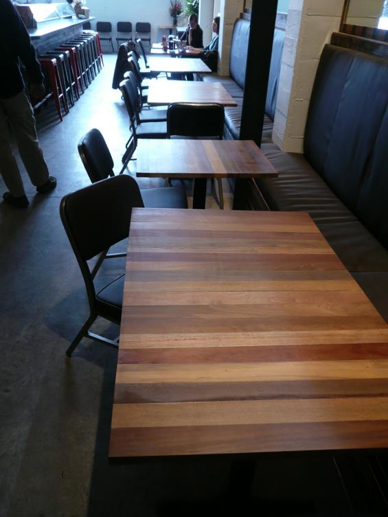 A mixture of exotic hardwoods were used for tables throughout this Portland Oregon European-style eatery. 