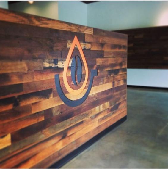 Nested within Settlers' Plank mixed hardwoods paneling, NEWwoodworks detailed the Pressed Cafe logo, completed with the cafe colors. 