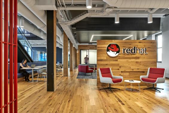 The American Gothic Oak flooring and paneling contrasts well with the branded colors of Red Hat in Boston, MA.