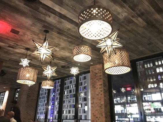 Reclaimed wood on the ceiling! This new bar in Boston features our American Prairie Corral Board paneling.