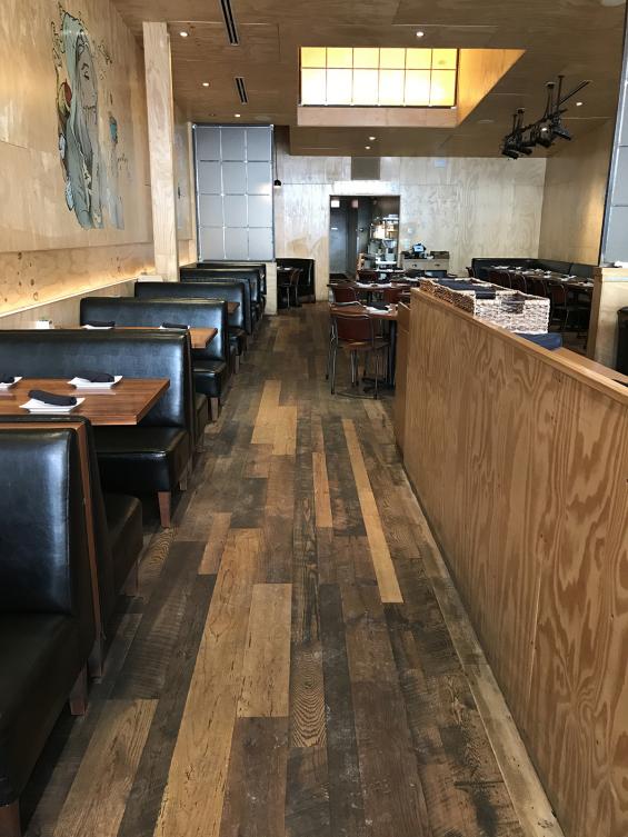 The flooring at Umami Burger in Chicago, IL made up of reclaimed Settlers' Plank Mixed hardwoods.